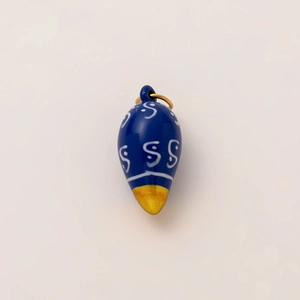Detailed macro view of blue teardrop flower pendant with gold plated metal link
