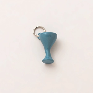 Macro detail of blue goblet-shaped charm with a silver metal ring attachment