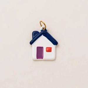 Detail of 18K gold plated stainless steel house pendant with colorful enamel finish
