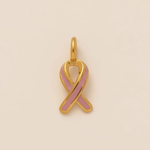 Detail of a 18K gold plated pink enamel ribbon charm pendant with cubic zirconia