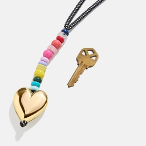 Colorful beaded keychain with a large gold heart pendant and black-white braided cord