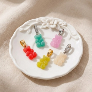 Colorful resin gummy bear pendants with frosted texture and rhinestone metal hooks