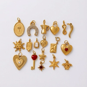 16-piece set of vintage gold-plated jewelry charms featuring sun, star, and heart motifs