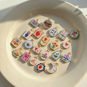 Pastel heart and floral DIY pendants in a ceramic bowl, minimalist vintage copper jewelry