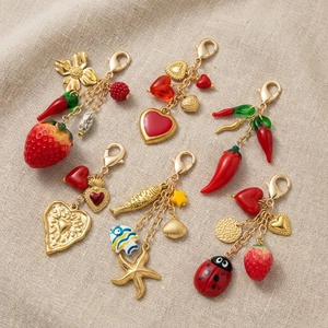 Colorful summer charms featuring strawberry heart and starfish pendants with lobster clasps