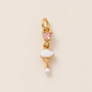 Macro shot of ballerina pendant with pink heart gemstone and white enamel finish