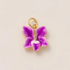 Detail of purple orchid flower pendant with enamel petals and gold plated jump ring