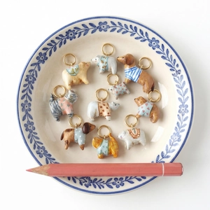 10-piece set of hand-painted ceramic animal pendants for DIY necklaces in a decorative bowl