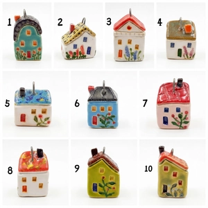 Detailed macro view of ten colorful hand-painted ceramic house pendants with metal loops