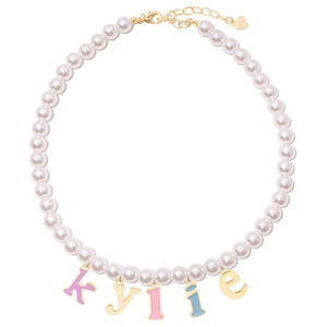 Detail of custom pearl necklace featuring colorful enamel letter charms spelling kylie