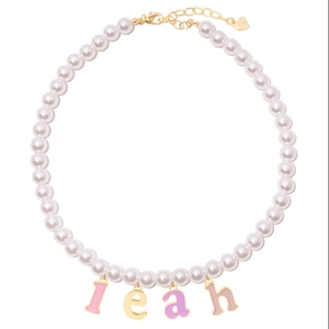 Detail of pearl necklace with colorful 'leah' letter charms and gold lobster clasp