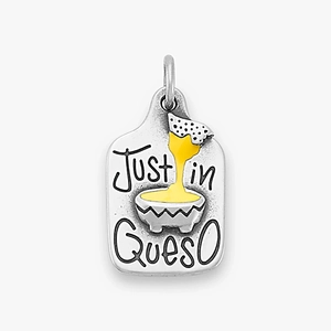 Macro view of vintage silver Just in Queso pendant with yellow enamel cheese dip