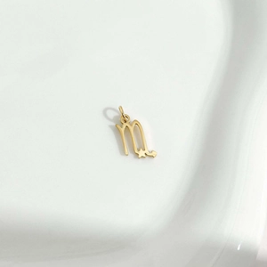 Golden titanium steel Scorpio zodiac necklace pendant with star detail on white background