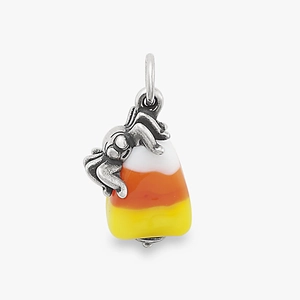 Detailed macro view of a vintage silver spider charm with a tri-color candy corn pendant
