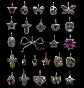 Macro shot of assorted Y2K vintage heart and star charms with colorful zircon crystals