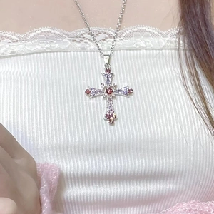 Detail view of gothic Y2K silver cross necklace with pink and purple zircon stones