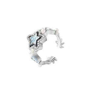Macro shot of a silver star ear cuff with blue enamel, sparkling zircons and white pearls