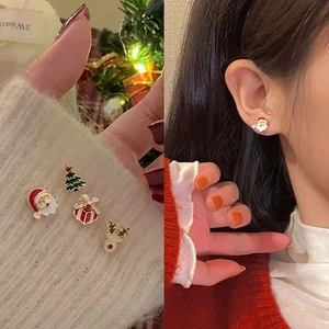 Cute 4-piece Christmas stud earring set with Santa, reindeer, and tree on white sweater