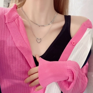 Double-layered titanium steel heart snake chain necklace shown on pink knitwear