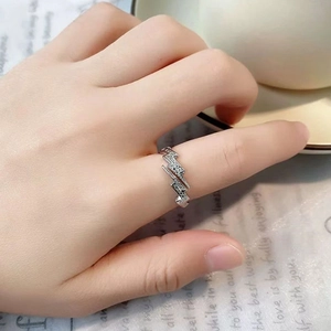 Close-up of adjustable silver lightning bolt ring with sparkling pavé zircons on finger