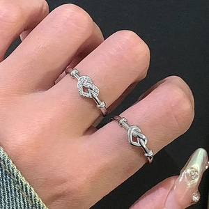Elegant silver knot rings for couples featuring minimalist smooth and zircon-inlaid designs