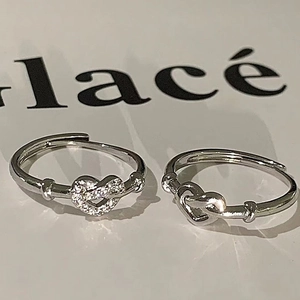 Adjustable silver heart knot rings for couples featuring sparkling paved stones and smooth finish