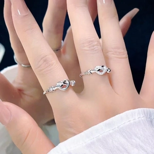 Elegant silver knot ring set with polished metal and pavé diamonds for couples