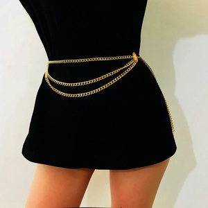 Detail of a vintage layered gold metal chain belt with flat link design and O-ring connector