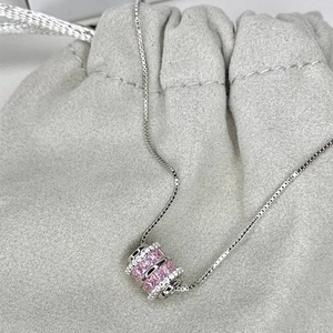 Macro de colgante de cilindro plateado con circón rosa y piedras en bolsa de terciopelo