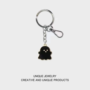 Close-up of black ghost enamel keychain with zinc alloy base and metal spring clasp