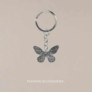 Vintage silver butterfly keychain with intricate hollow wing details and metal ring
