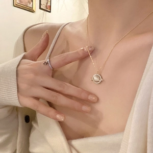 Chic gold titanium steel necklace with sparkling planet pendant on model for elegant look