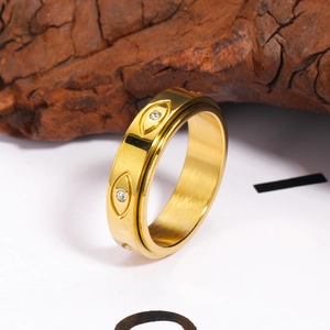 Bague rotative en acier inoxydable doré brossé avec motifs d'yeux et pierres en zircon
