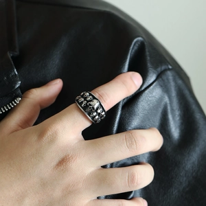 Macro detail of men's vintage double-row skull ring in rugged punk stainless steel