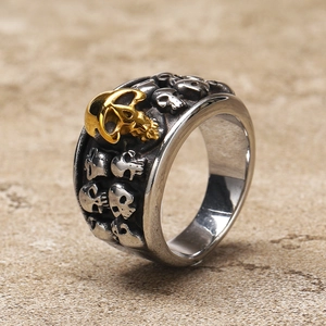 Detail shot of vintage skull ring with silver relief and a gold plated centerpiece