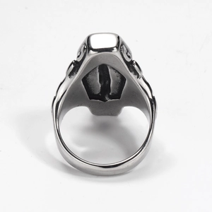 Macro shot of gothic coffin-shaped top and vintage scroll carvings on silver steel ring