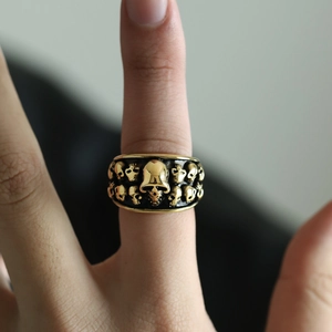 Vintage gold skull ring in stainless steel with detailed gothic embossing on a wide band