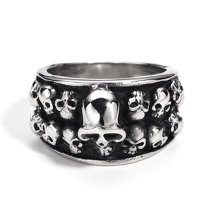Macro detail of gothic skull ring in matte silver steel with vintage embossed patterns
