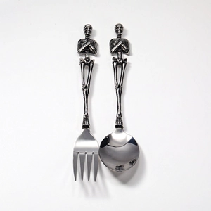 Detailed top view of gothic skull handle stainless steel fork and spoon cutlery set