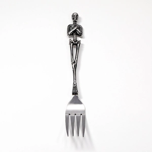 Retro stainless steel dinner fork featuring a detailed gothic skull handle design