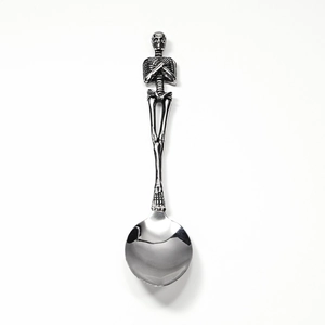 Gothic skull handle stainless steel spoon with polished silver finish on white background