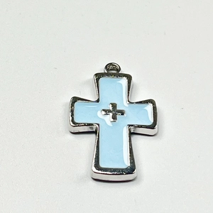 Detail of light blue enamel cross pendant with silver metal edges and minimalist design