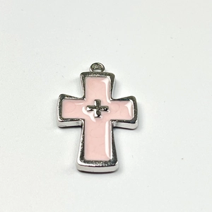 Macro shot of pink and silver cross pendant with layered Y2K gothic style design