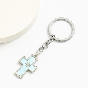 Silver double cross keychain with light blue marble inlay on a clean white background