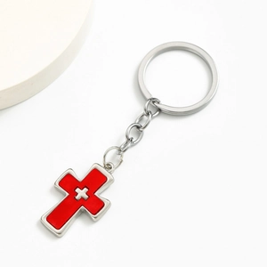 Silver metal double cross keychain with red enamel pendant on a clean white background