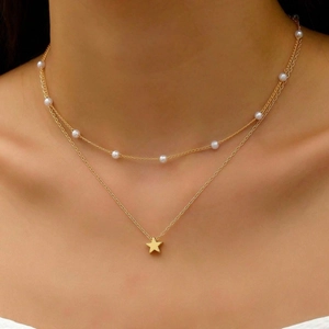 Double-layered gold necklace with white pearls and a minimalist star pendant for women