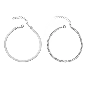 Detailed view of silver layered snake and cuban link anklets with lobster clasps