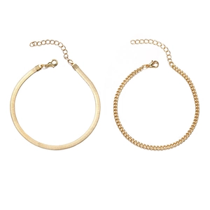 Detail of gold-plated herringbone and curb chains with lobster clasps and extenders