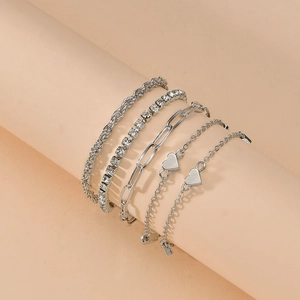 Detail of 5-piece silver bracelet set with heart charms, rhinestones and paperclip links