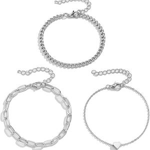 Detail of silver chain bracelet set featuring lobster clasps and heart pendant